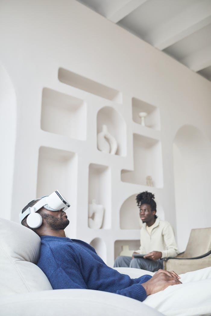 Adults relaxing with VR headset in modern indoor setting.